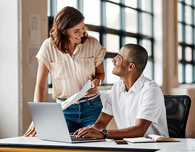 Two people looking at a computer