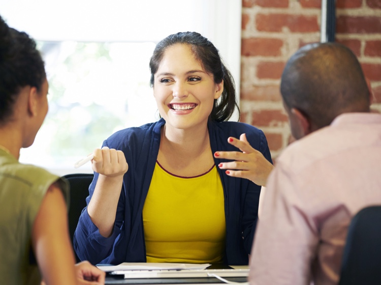 Woman smiling while talking to others